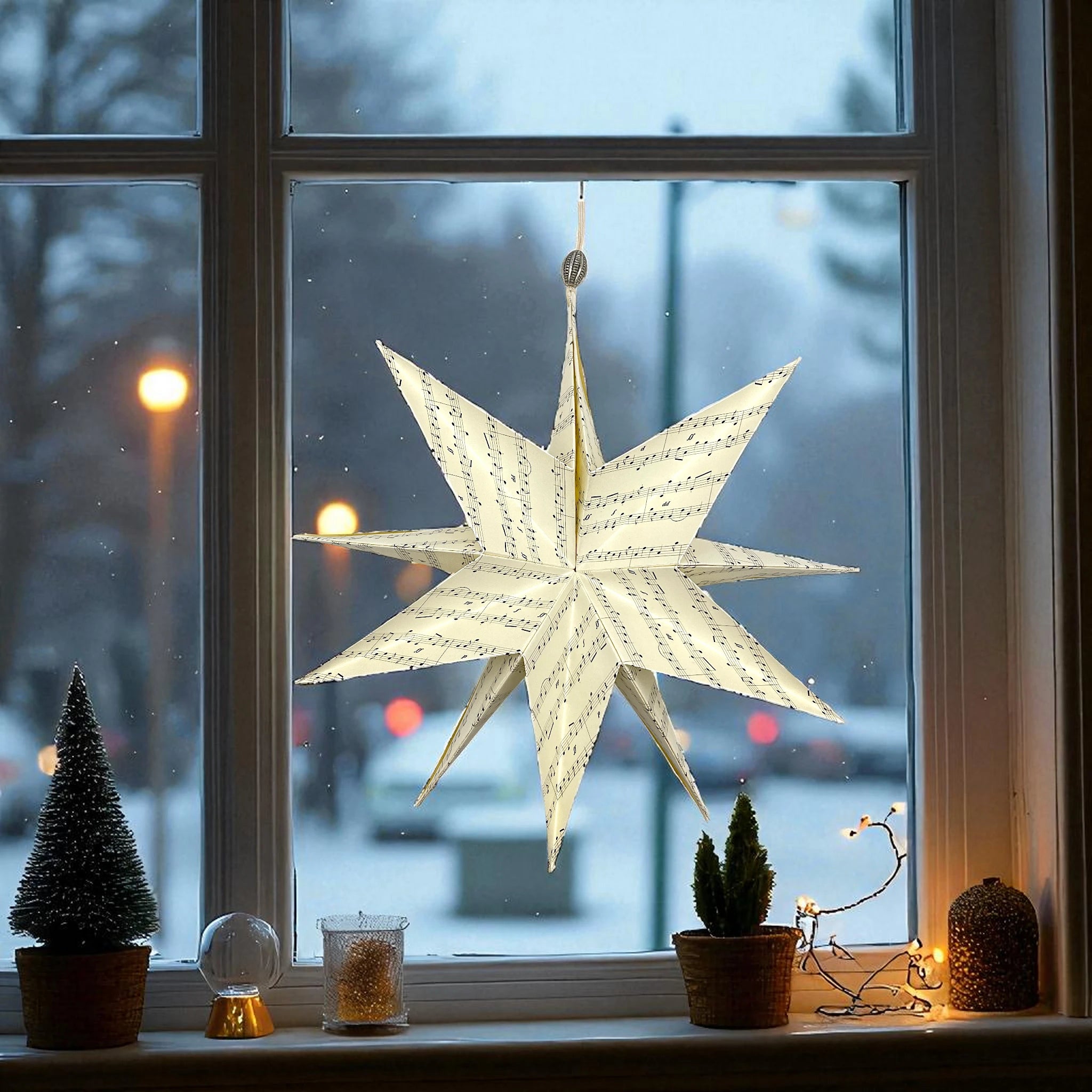In Handarbeit gemachter Papierstern in einem Fenster mit einem Stern.
