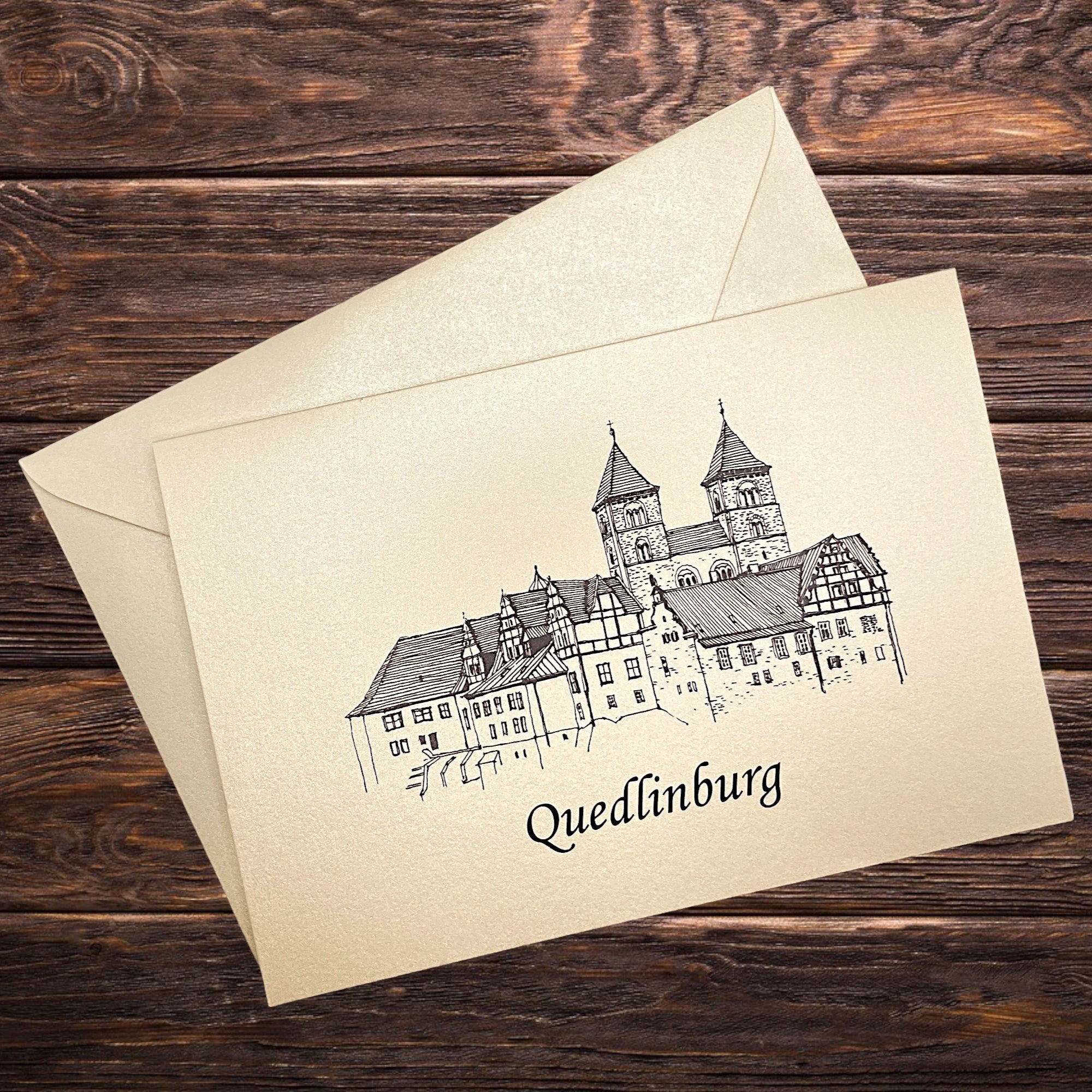 Klappkarte mit Schloss Quedlinburg, dekorativ präsentiert auf rustikalem Holztisch