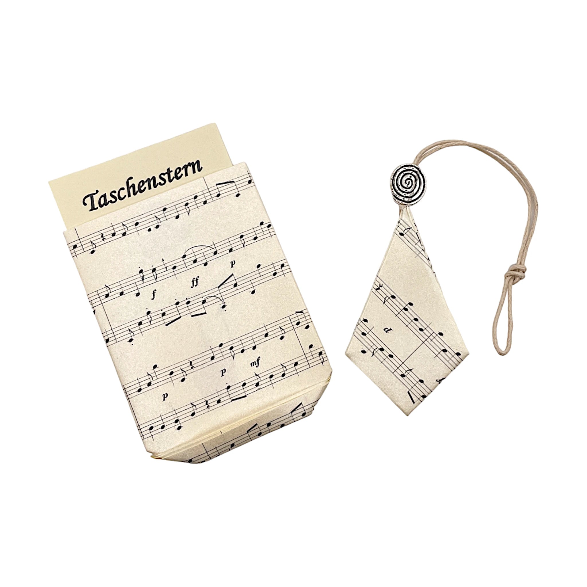 Zusammengelegter Papierstern mit feinem Notendruck, geschützt im passenden Etui