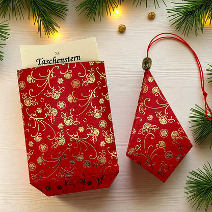 Stern aus Papier in rot und gold auf einem Tisch